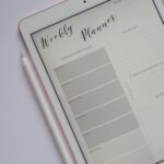 Weekly planner shown on a tablet with a stylus pen